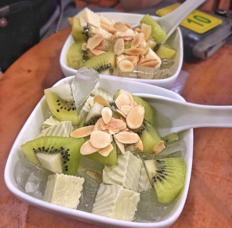 Chè khúc bạch nhiều màu sắc với khối khúc bạch trà xanh, long nhãn, trái cây tươi và hạnh nhân lát, món đặc trưng tại quán chè ngon Khúc Bạch Thanh Quận 5.
